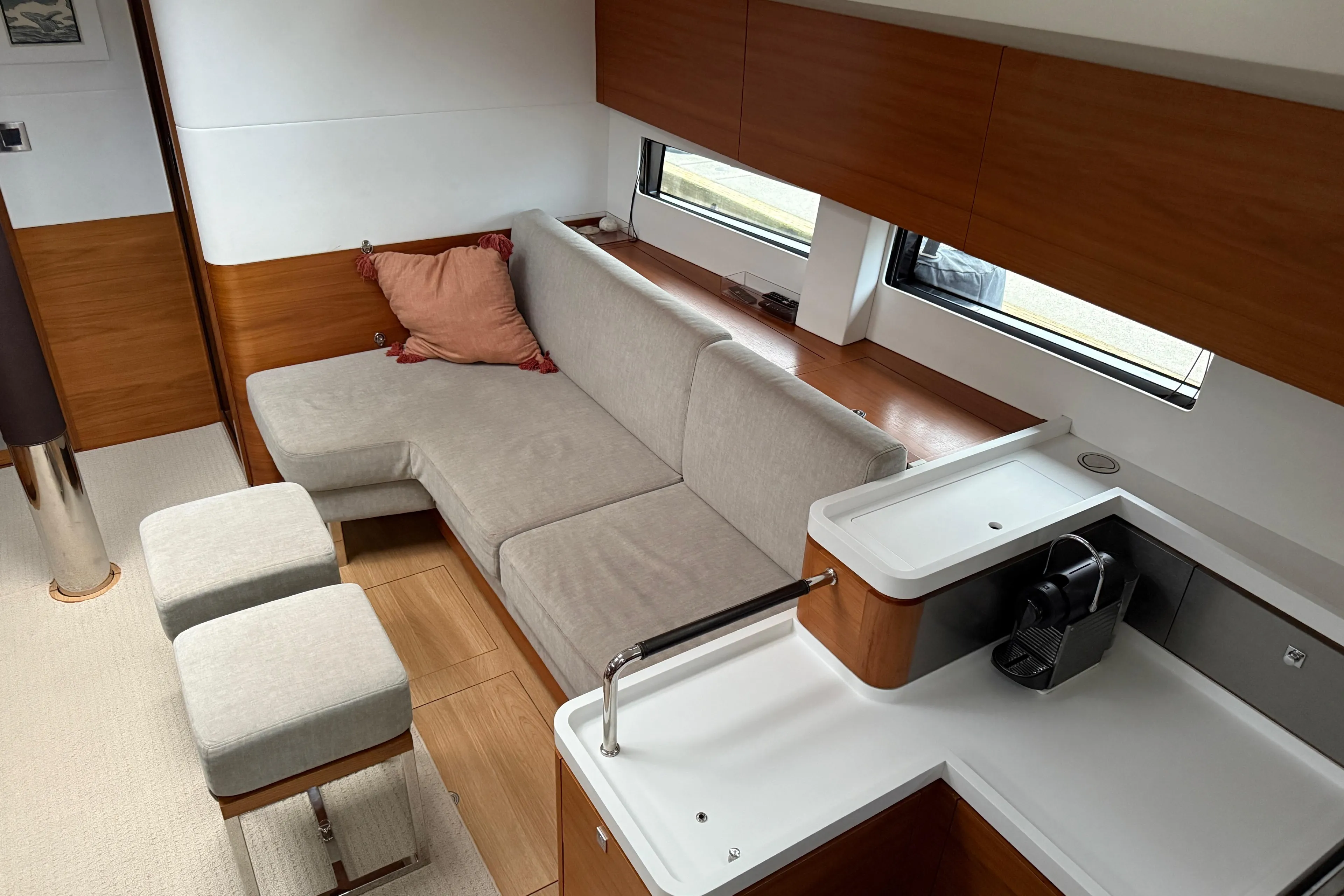 Modern interior of 2020 Amel 50 yacht with cozy seating and sleek kitchen area.