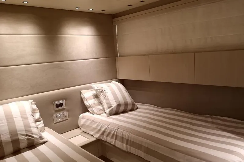  Yacht Photos Pics Luxurious twin cabin interior of 2011 Sanlorenzo 72 yacht with striped bedding.