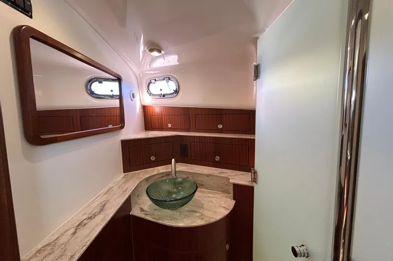  Yacht Photos Pics Luxurious bathroom interior of 2018 Pursuit OS 385 Offshore yacht with modern fixtures.