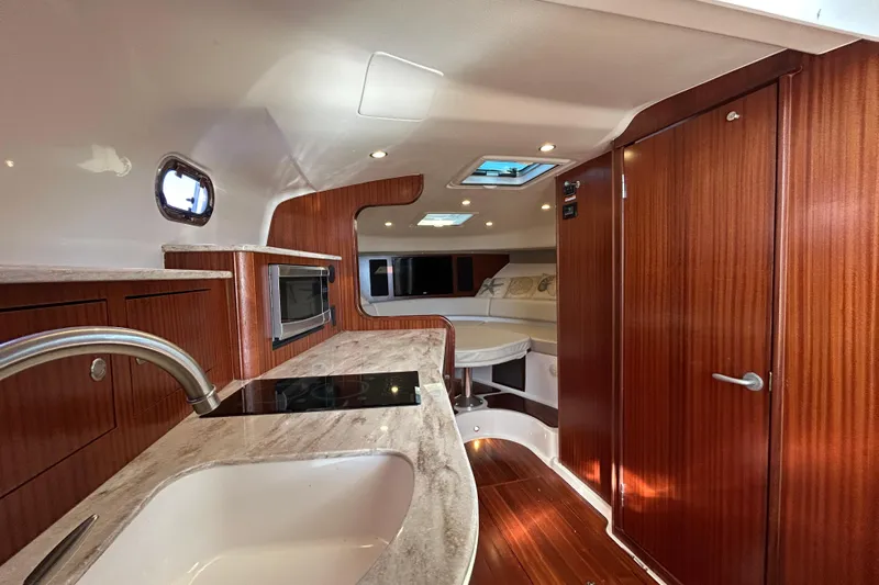  Yacht Photos Pics Luxurious interior of 2018 Pursuit OS 385 Offshore boat with modern amenities.