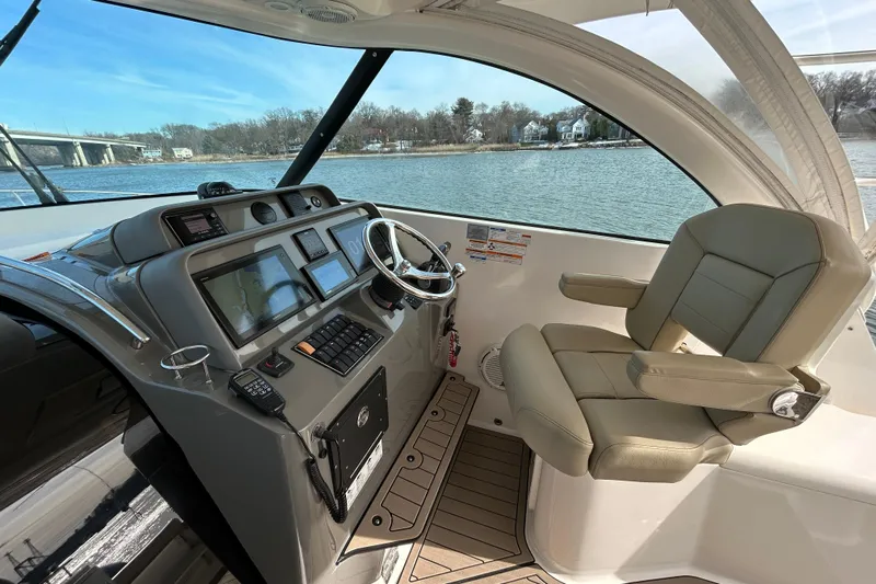  Yacht Photos Pics 2018 Pursuit OS 385 Offshore helm with modern navigation equipment and comfortable seating.