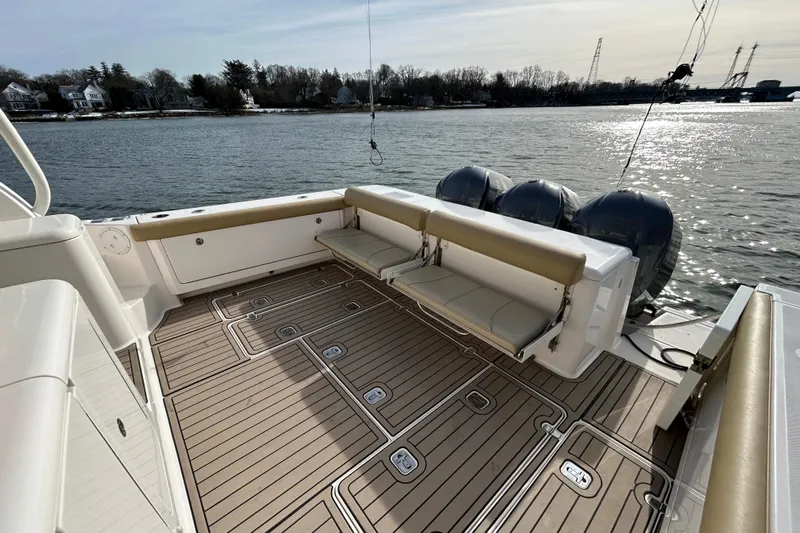  Yacht Photos Pics 2018 Pursuit OS 385 Offshore boat deck with seating, overlooking calm waters.
