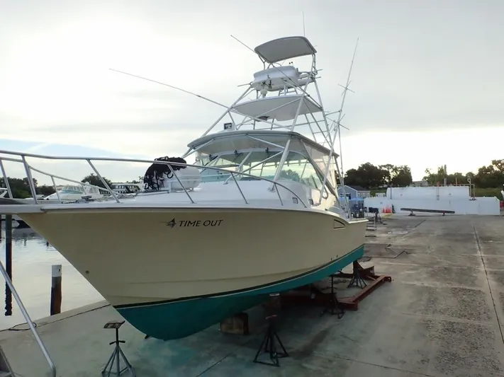 Time Out Yacht Photos Pics 2000 Cabo 35 Express boat on dry dock, ready for maintenance.