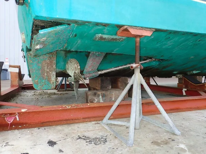 Time Out Yacht Photos Pics Cabo 35 Express 2000 boat hull on dry dock with visible propeller and support stands.