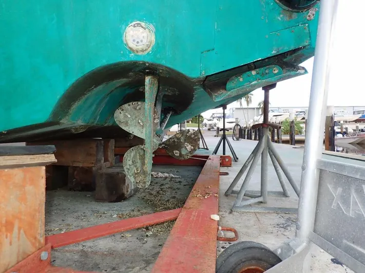 Time Out Yacht Photos Pics Cabo 35 Express 2000 boat on dry dock, showing propeller and hull maintenance.