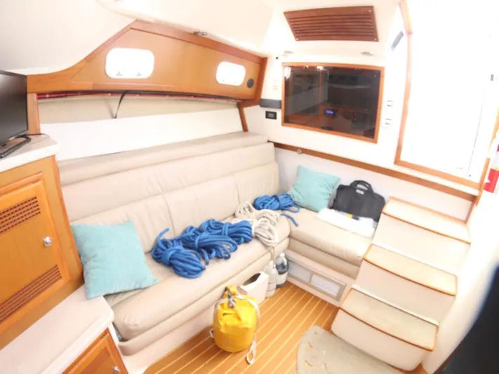 Time Out Yacht Photos Pics Interior of 2000 Cabo 35 Express boat with cozy seating and nautical decor.