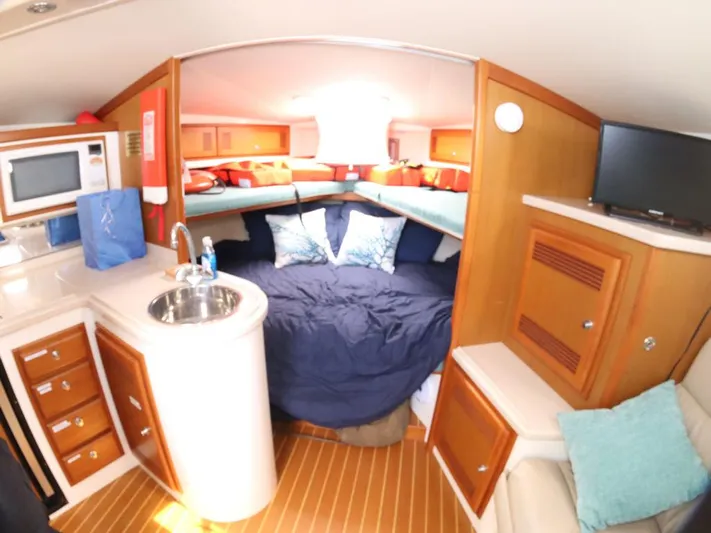 Time Out Yacht Photos Pics Interior of 2000 Cabo 35 Express boat with cozy cabin and kitchenette.
