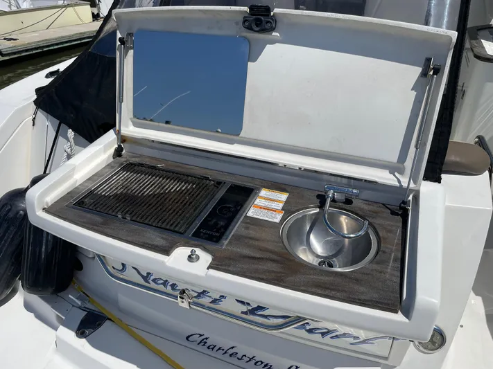  Yacht Photos Pics Outdoor kitchenette on a 2014 Sea Ray 370 Sundancer yacht with grill and sink.