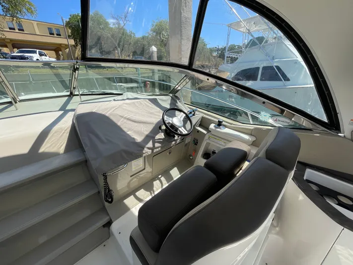  Yacht Photos Pics Cockpit of 2014 Sea Ray 370 Sundancer with covered helm and black seating.