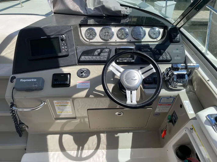  Yacht Photos Pics 2014 Sea Ray 370 Sundancer helm with steering wheel, gauges, and navigation equipment.