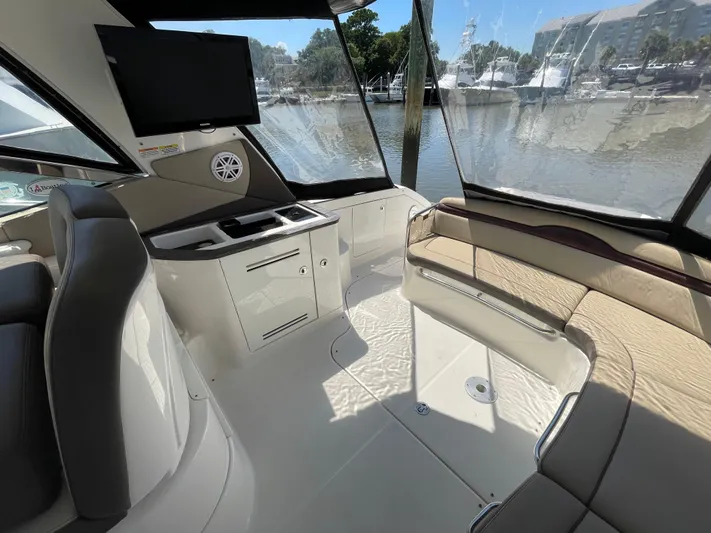  Yacht Photos Pics Interior of 2014 Sea Ray 370 Sundancer yacht with seating, TV, and waterfront view.