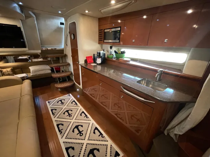  Yacht Photos Pics Interior of 2014 Sea Ray 370 Sundancer yacht with modern kitchen and cozy seating area.
