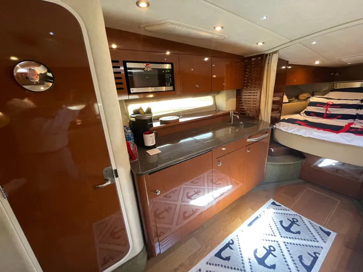  Yacht Photos Pics Interior of 2014 Sea Ray 370 Sundancer with kitchen and bed area.