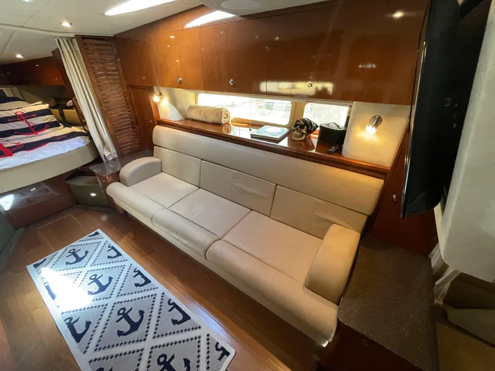  Yacht Photos Pics Interior of 2014 Sea Ray 370 Sundancer yacht with beige sofa and nautical decor.