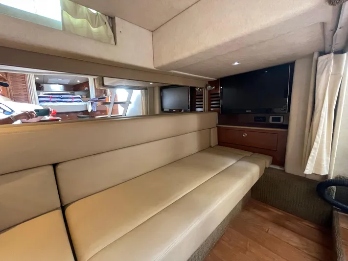  Yacht Photos Pics Interior of 2014 Sea Ray 370 Sundancer with beige seating and TV.