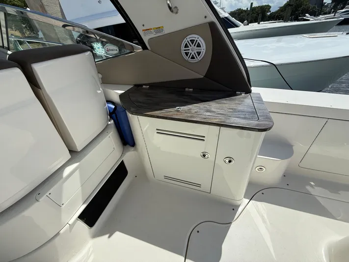  Yacht Photos Pics 2014 Sea Ray 370 Sundancer cockpit with storage cabinets and seating area.