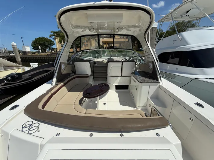  Yacht Photos Pics 2014 Sea Ray 370 Sundancer boat with spacious seating and sleek design at a marina.
