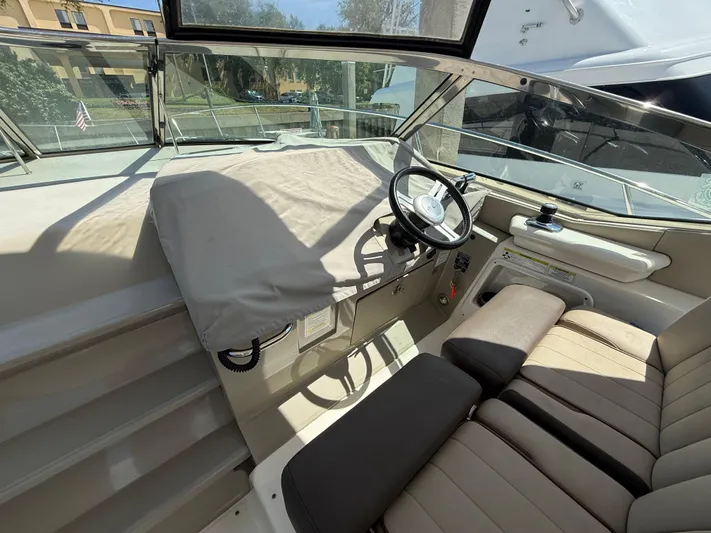  Yacht Photos Pics 2014 Sea Ray 370 Sundancer helm with covered dashboard and comfortable seating.