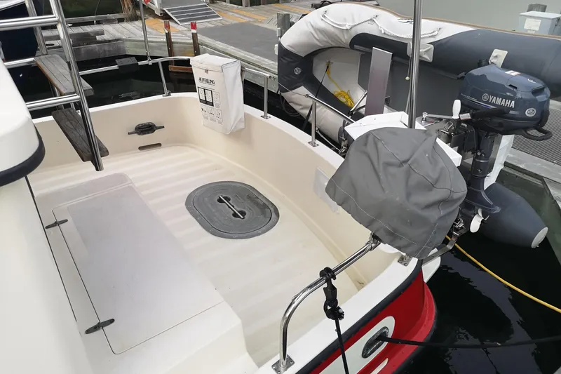  Yacht Photos Pics Nordic Tug 32 (1990) boat deck with Yamaha motor and lifebuoy.