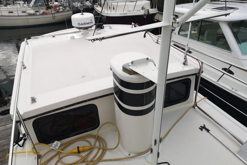  Yacht Photos Pics 1990 Nordic Tug 32 boat deck with Garmin equipment, docked at marina.