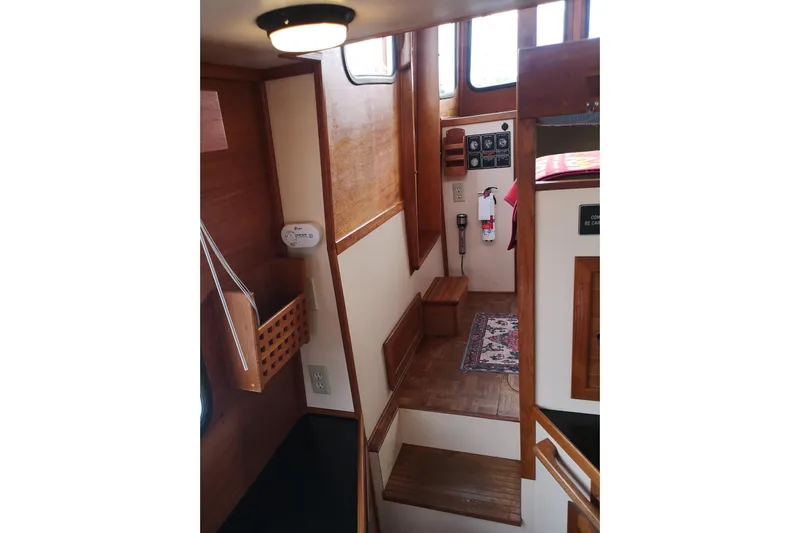  Yacht Photos Pics Interior of 1990 Nordic Tug 32, featuring wooden stairs and nautical decor.