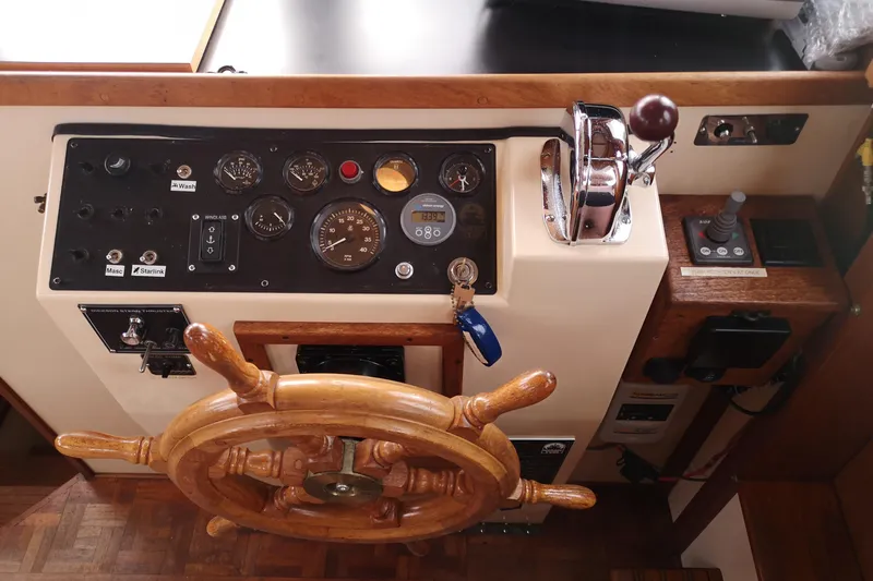  Yacht Photos Pics 1990 Nordic Tug 32 helm with wooden wheel, gauges, and controls.