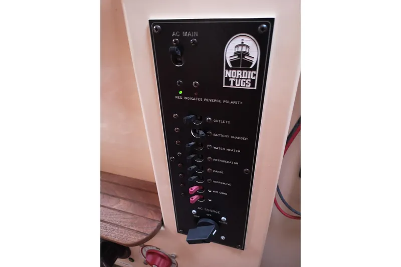 Yacht Photos Pics Electrical panel of a 1990 Nordic Tug 32 boat, featuring various switches and controls.