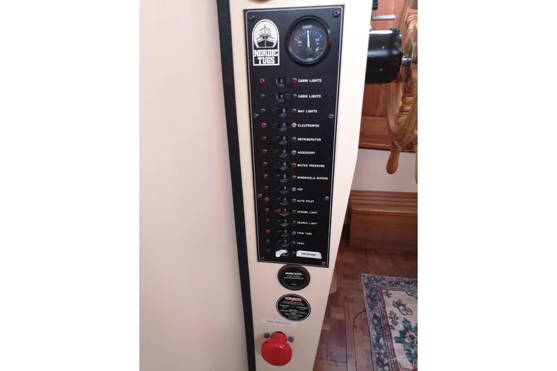  Yacht Photos Pics Control panel of a 1990 Nordic Tug 32 boat, featuring various switches and gauges.