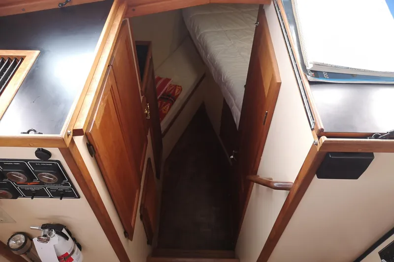  Yacht Photos Pics Interior view of 1990 Nordic Tug 32, featuring cozy cabin and wooden finishes.