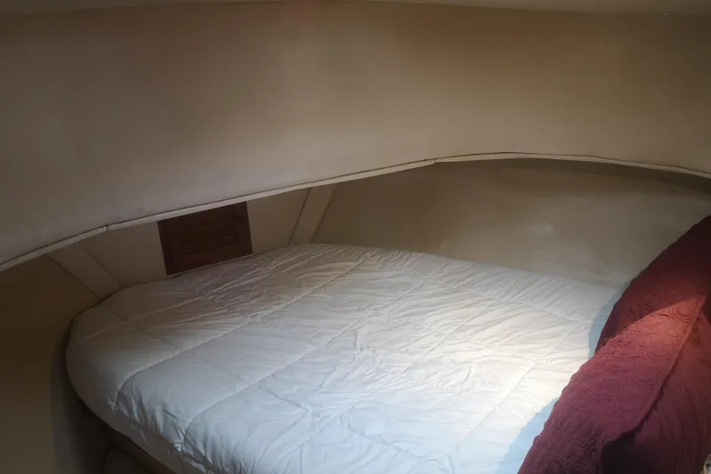  Yacht Photos Pics Cozy cabin interior of 1990 Nordic Tug 32 with comfortable bedding.