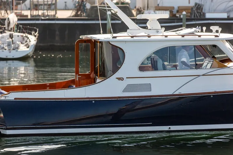 Summer Yacht Photos Pics 2002 Hinckley Talaria 44 yacht with sleek design, docked in a marina.