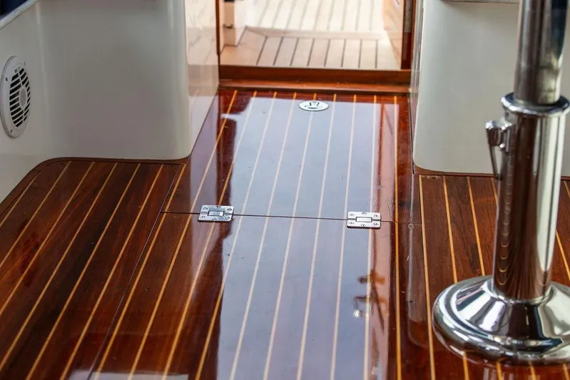 Summer Yacht Photos Pics Hinckley Talaria 44 (2002) yacht interior with polished wooden flooring and chrome details.