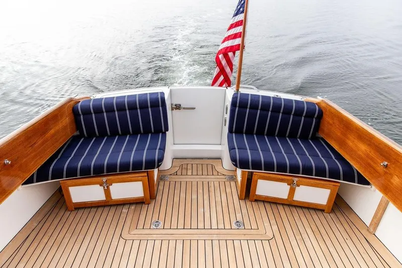 Summer Yacht Photos Pics Hinckley Talaria 44 yacht deck with striped seating and American flag, 2002 model.