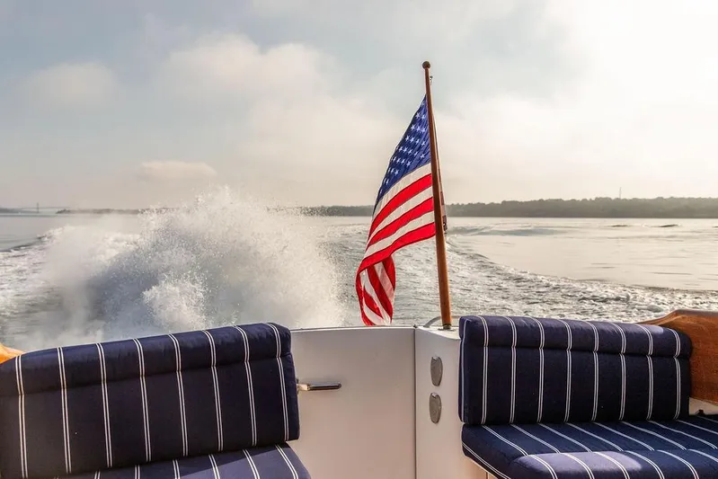 Summer Yacht Photos Pics Hinckley Talaria 44 yacht cruising, American flag waving, 2002 model, ocean view.