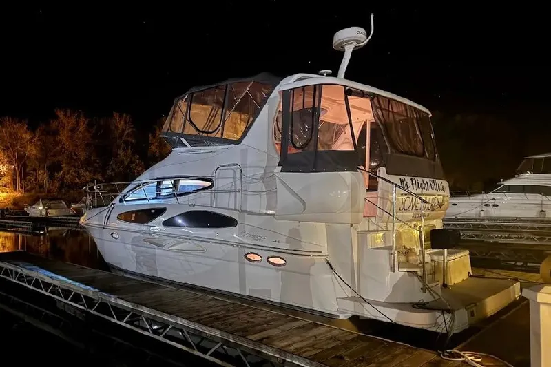 It's Flight O'clock Somewhere Yacht Photos Pics 2006 Cruisers Yachts 385 Motoryacht docked at night, illuminated by soft lighting.
