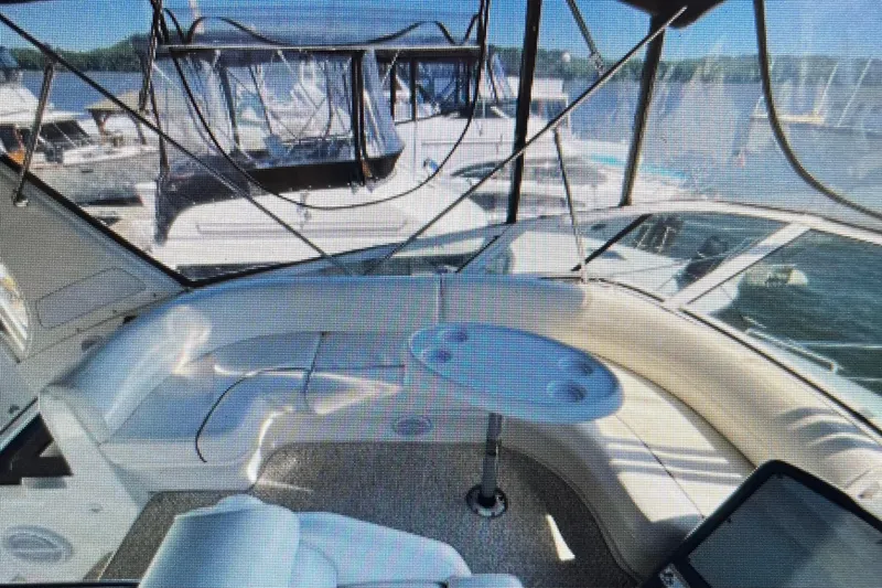 It's Flight O'clock Somewhere Yacht Photos Pics 2006 Cruisers Yachts 385 Motoryacht interior with seating and table, docked at marina.