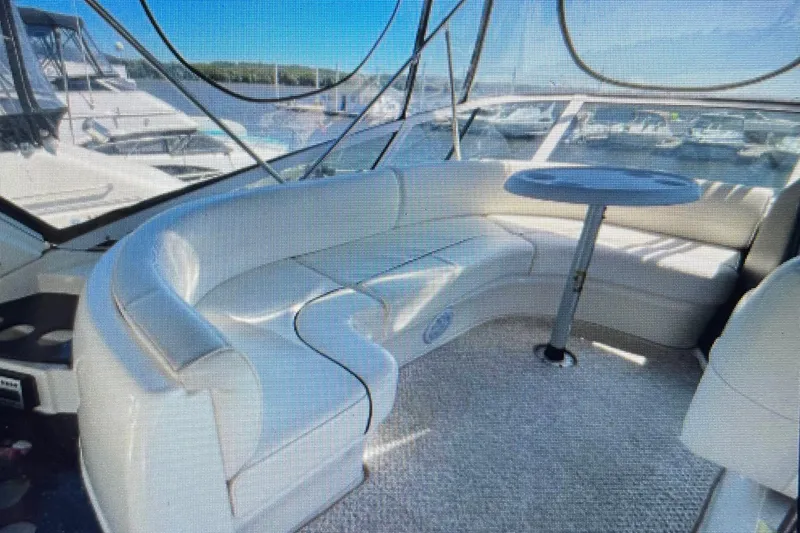 It's Flight O'clock Somewhere Yacht Photos Pics Luxurious interior of 2006 Cruisers Yachts 385 Motoryacht with plush seating and table.