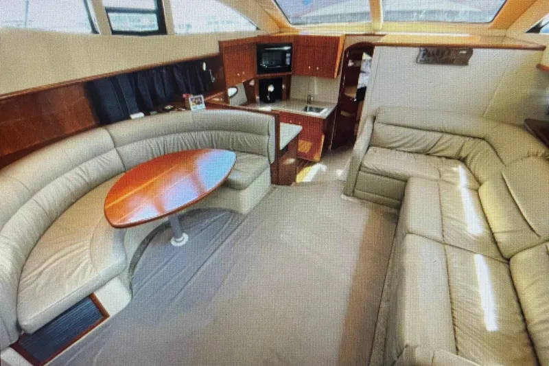 It's Flight O'clock Somewhere Yacht Photos Pics Luxurious interior of 2006 Cruisers Yachts 385 Motoryacht with leather seating and wood accents.