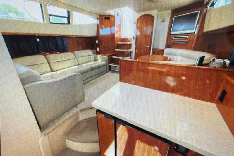 It's Flight O'clock Somewhere Yacht Photos Pics Luxurious interior of 2006 Cruisers Yachts 385 Motoryacht with elegant seating and wood finishes.