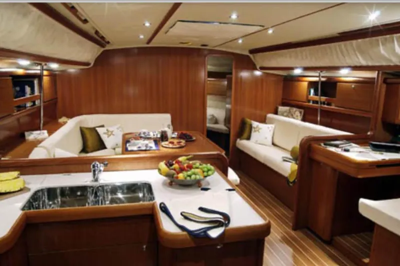  Yacht Photos Pics Luxurious interior of 2009 Grand Soleil 50 yacht with elegant wood finish and cozy seating.