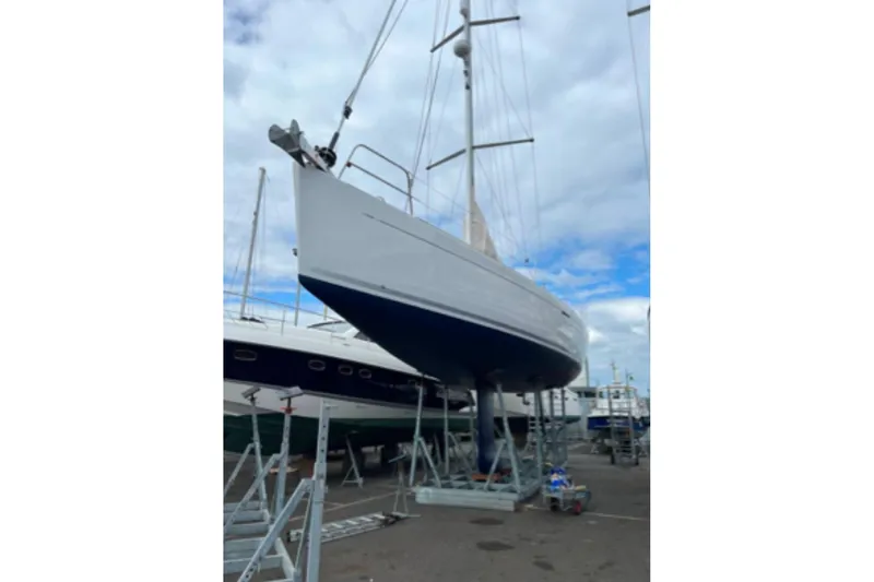  Yacht Photos Pics 2009 Grand Soleil 50 sailboat on dry dock, under a cloudy sky.