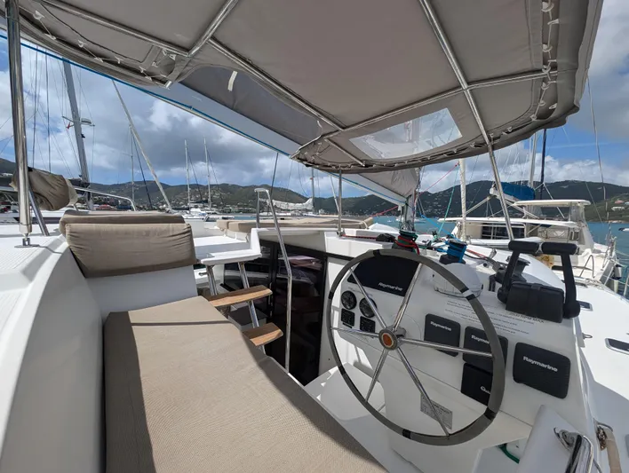Anila Yacht Photos Pics 2018 Fountaine Pajot Helia 44 Evolution catamaran helm with seating, docked in a marina.
