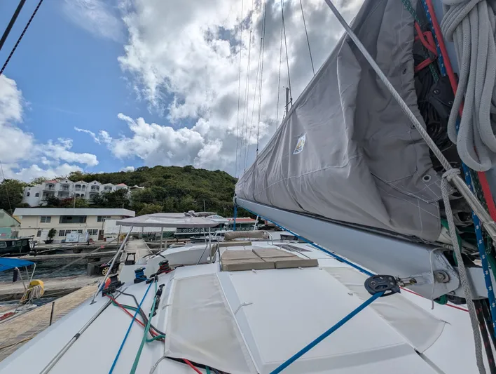 Anila Yacht Photos Pics Fountaine Pajot Helia 44 Evolution 2018 catamaran docked, sails down, with scenic background.