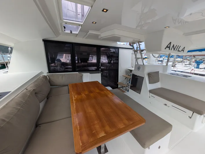 Anila Yacht Photos Pics Spacious interior of 2018 Fountaine Pajot Helia 44 Evolution catamaran with seating and table.