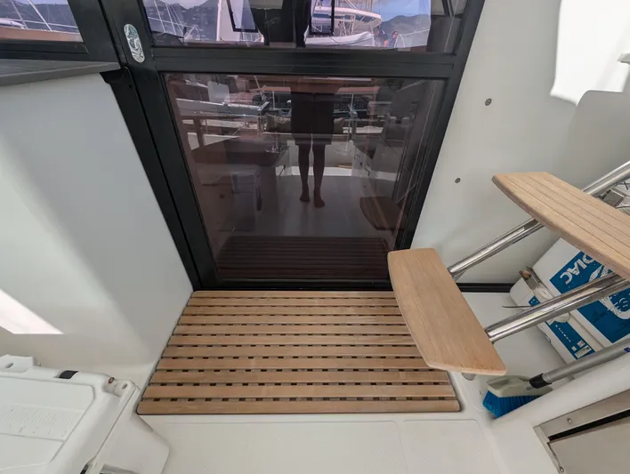 Anila Yacht Photos Pics Fountaine Pajot Helia 44 Evolution 2018 yacht interior with wooden steps and glass door.