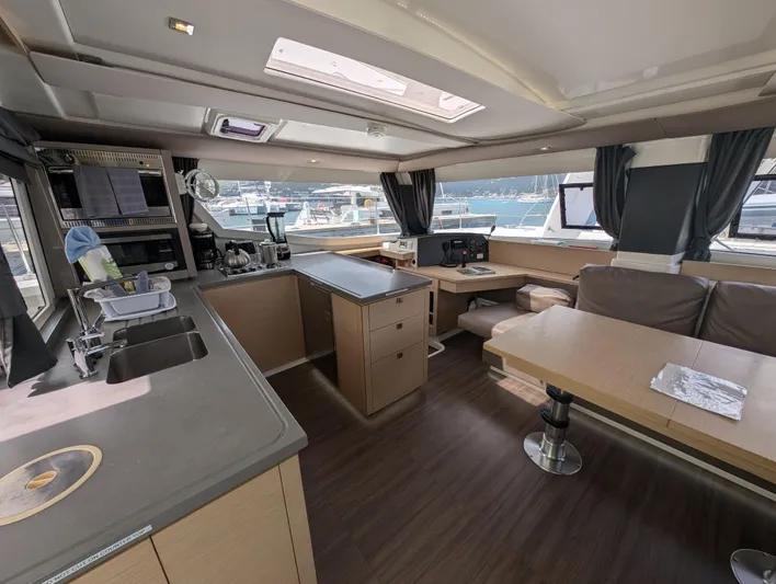 Anila Yacht Photos Pics Interior of 2018 Fountaine Pajot Helia 44 Evolution catamaran, featuring modern kitchen and dining area.