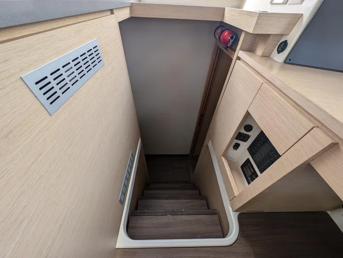 Anila Yacht Photos Pics Stairway inside 2018 Fountaine Pajot Helia 44 Evolution catamaran, featuring wooden steps and light wood paneling.