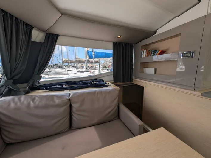 Anila Yacht Photos Pics Interior of 2018 Fountaine Pajot Helia 44 Evolution catamaran with cozy seating and window view.