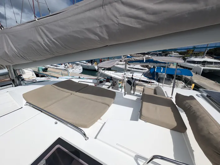 Anila Yacht Photos Pics 2018 Fountaine Pajot Helia 44 Evolution catamaran with sunbathing area, docked at marina.
