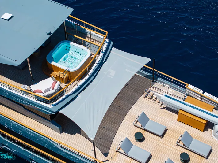 Oscar Yacht Photos Pics Luxurious 2023 Numarine 37XP yacht deck with hot tub and sun loungers.